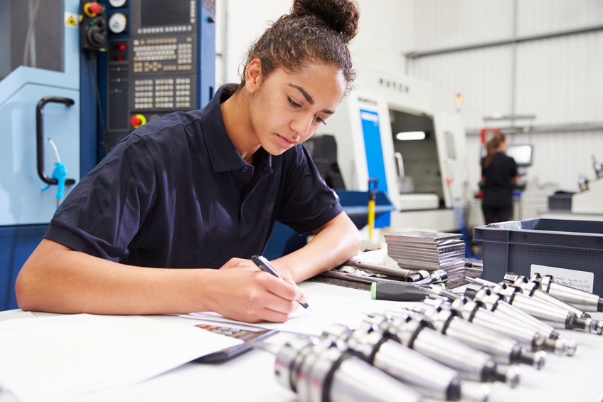 Woman engineer using a CNC machine