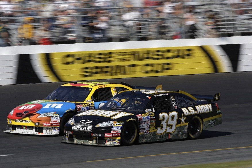 racing cars racing together on a track