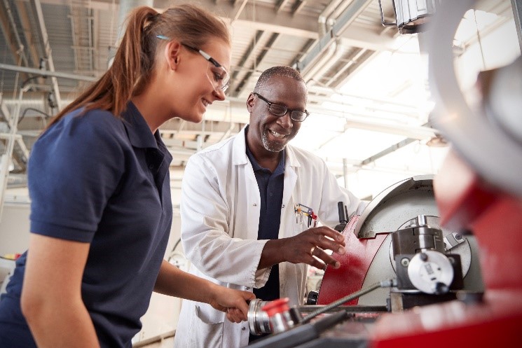 Apprentice Working With Experienced Worker