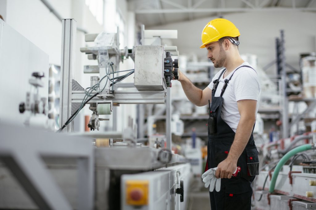 Portrait of factory worker. Young handsome factory worker.