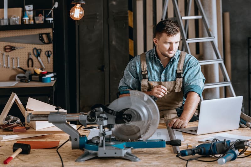 Man in workshop using laptop