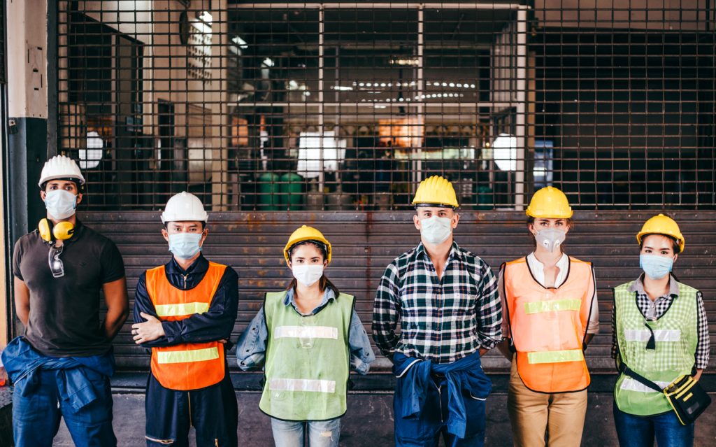 Happy engineers in masks