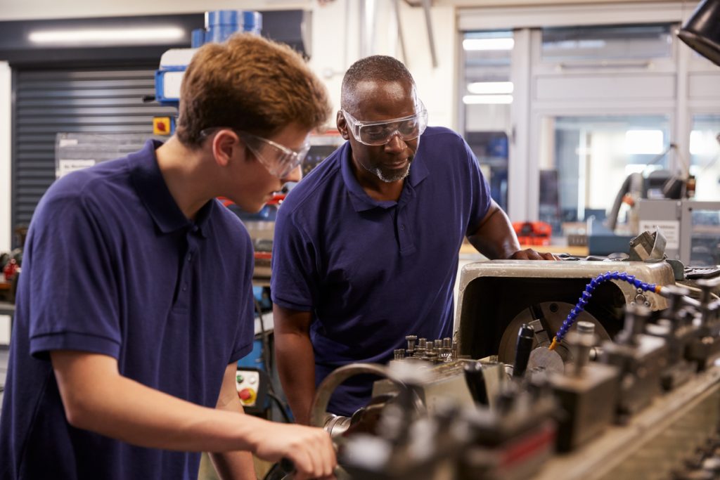 Engineer mentoring an apprentice