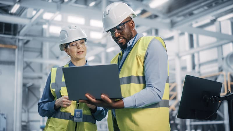 Male engineer teaching young female engineer