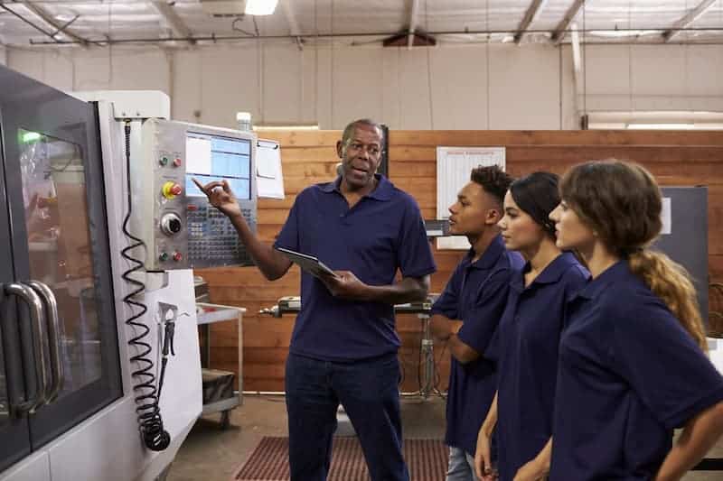 Engineer teaching apprentices