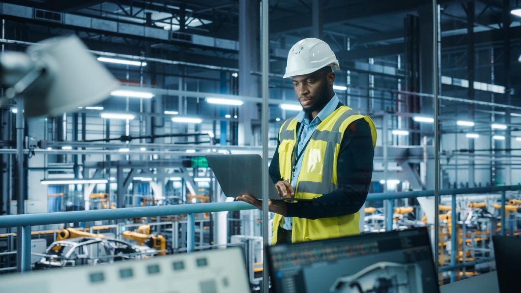 Engineer looking at a tablet in a factory