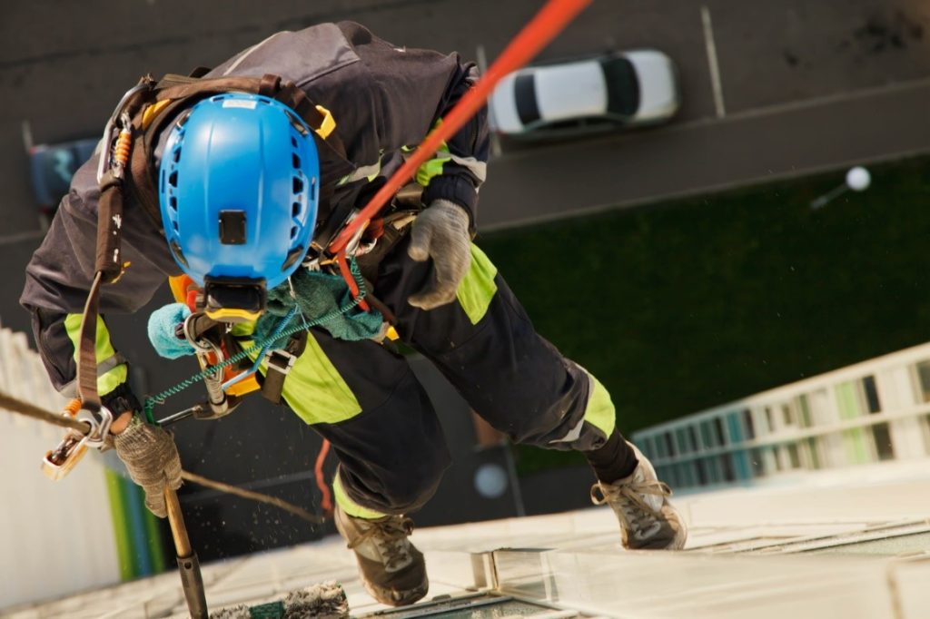 Someone working at height using spring-operated equipment