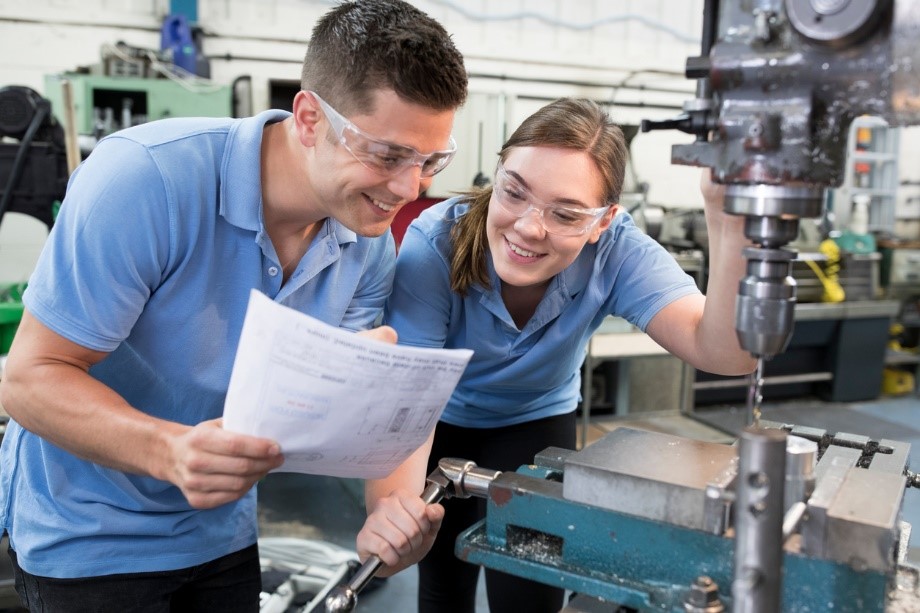 Two manufacturing engineers working together on a practical project