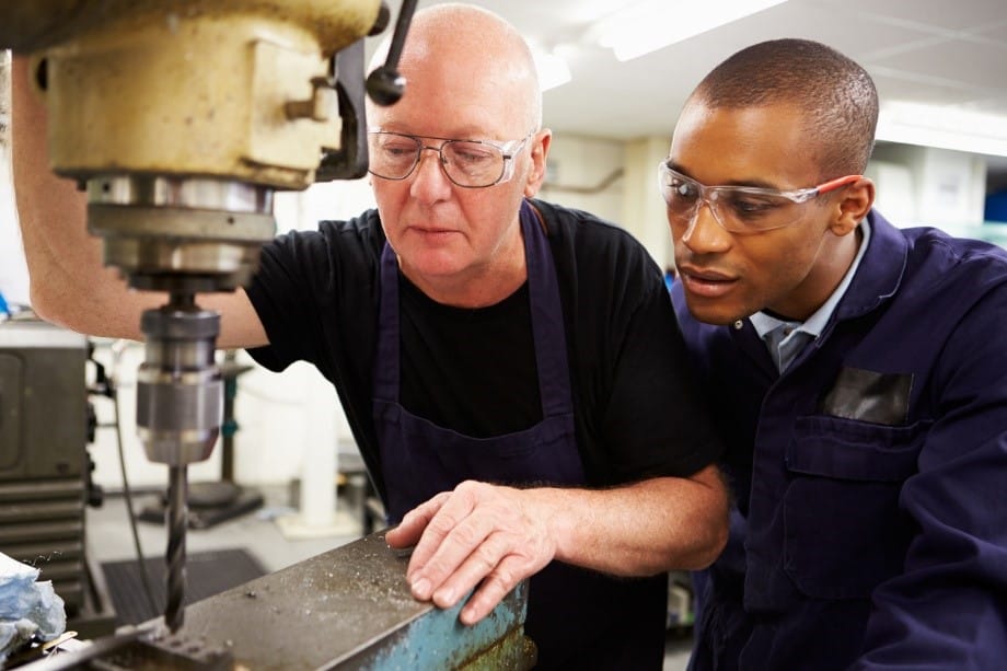 Senior engineer tutoring a manufacturing engineer