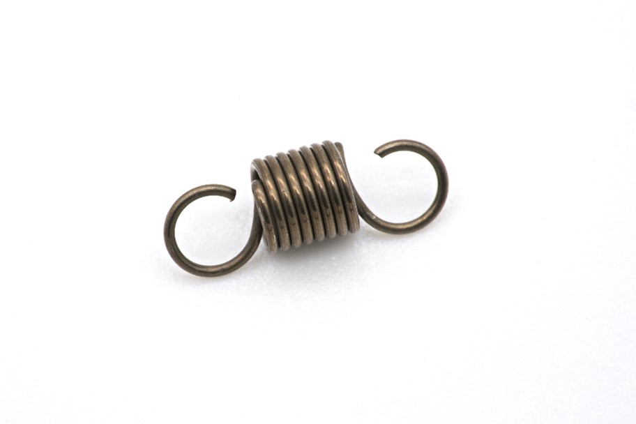 Single dark coloured metal spring with white background