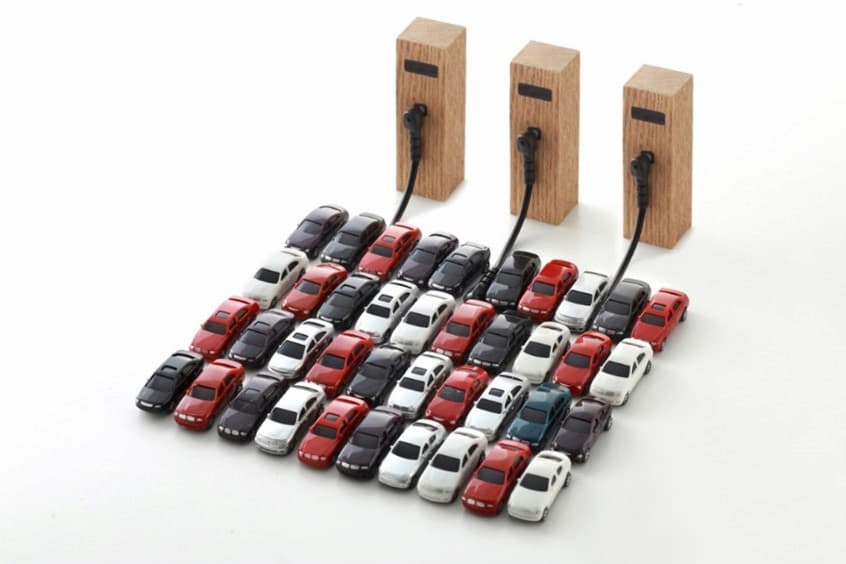 A group of toy cars connected to a power outlet