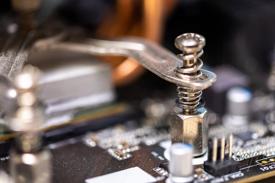 A close-up of a screw on a computer board