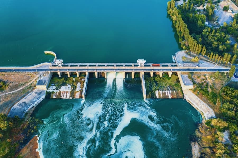 A water dam with a bridge and trees