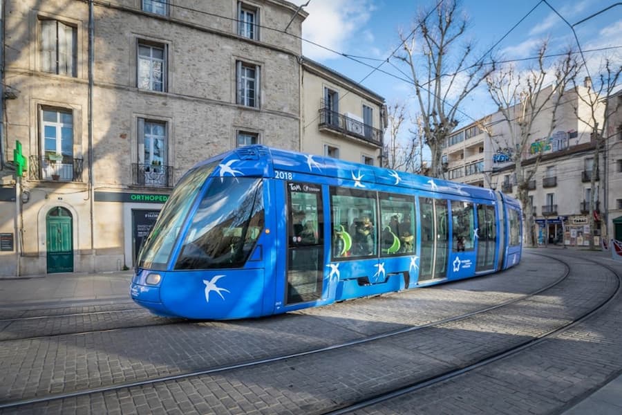 A blue tram on a street