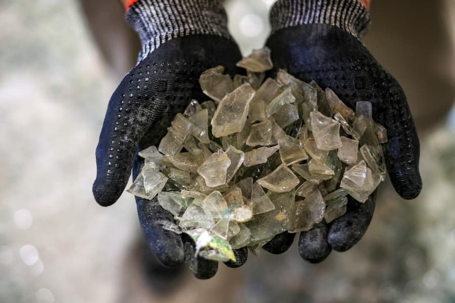 A person holding a pile of broken glass