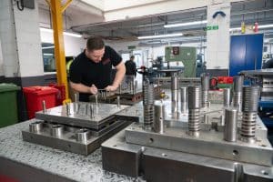 A group of people working on a tool transfer machine